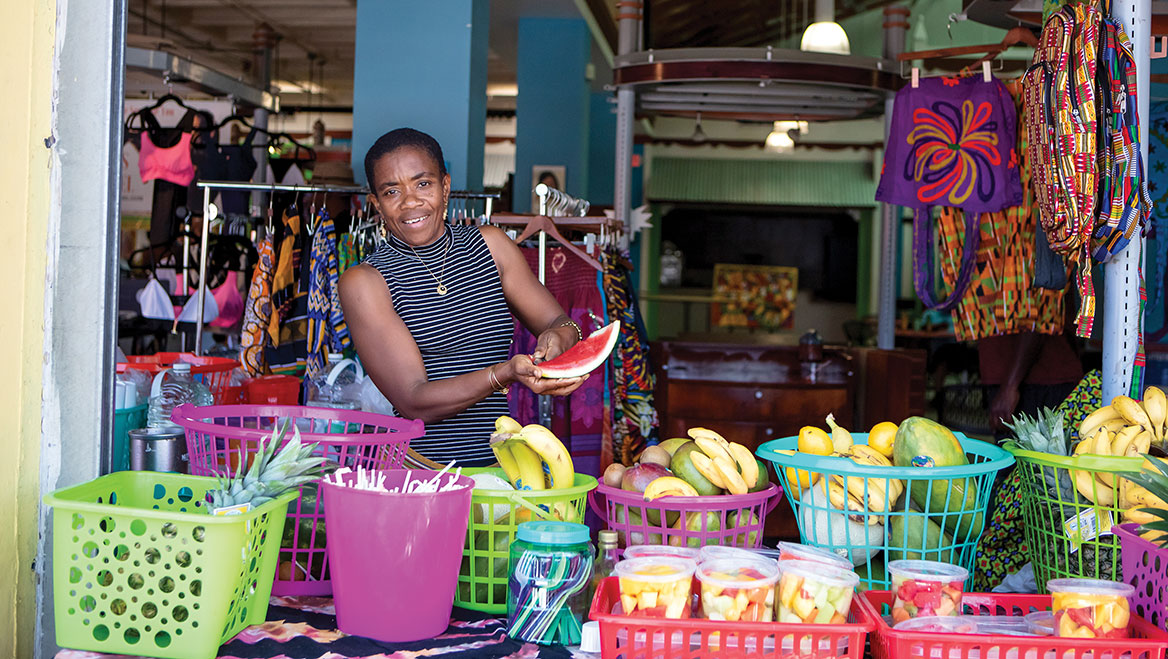 Caption: Located a few miles in from the coast, Miami’s Little Haiti neighborhood is being inundated by newcomers whose coastal properties are threatened by climate change-driven flooding. The shift is driving up housing prices and putting longtime residents and local businesses, like those in the Haitian Cultural Center (above), at risk of displacement. Photo courtesy of Greater Miami Convention