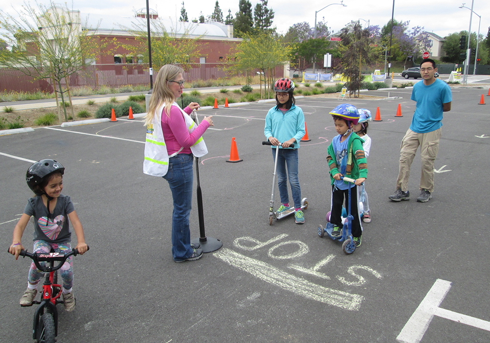 Children learn skills to stay safe while riding on streets and pathways during the Go Human event in Brea, California.