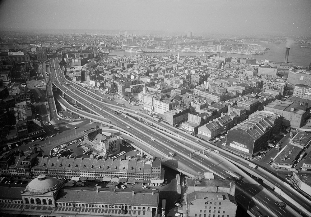 Aerial view of Boston, Massachusetts (1957) from Beacon Hill, showing the Central Artery freeway, buildings, and Charles River. Image courtesy of the Library of Congress's Prints and Photographs Division.