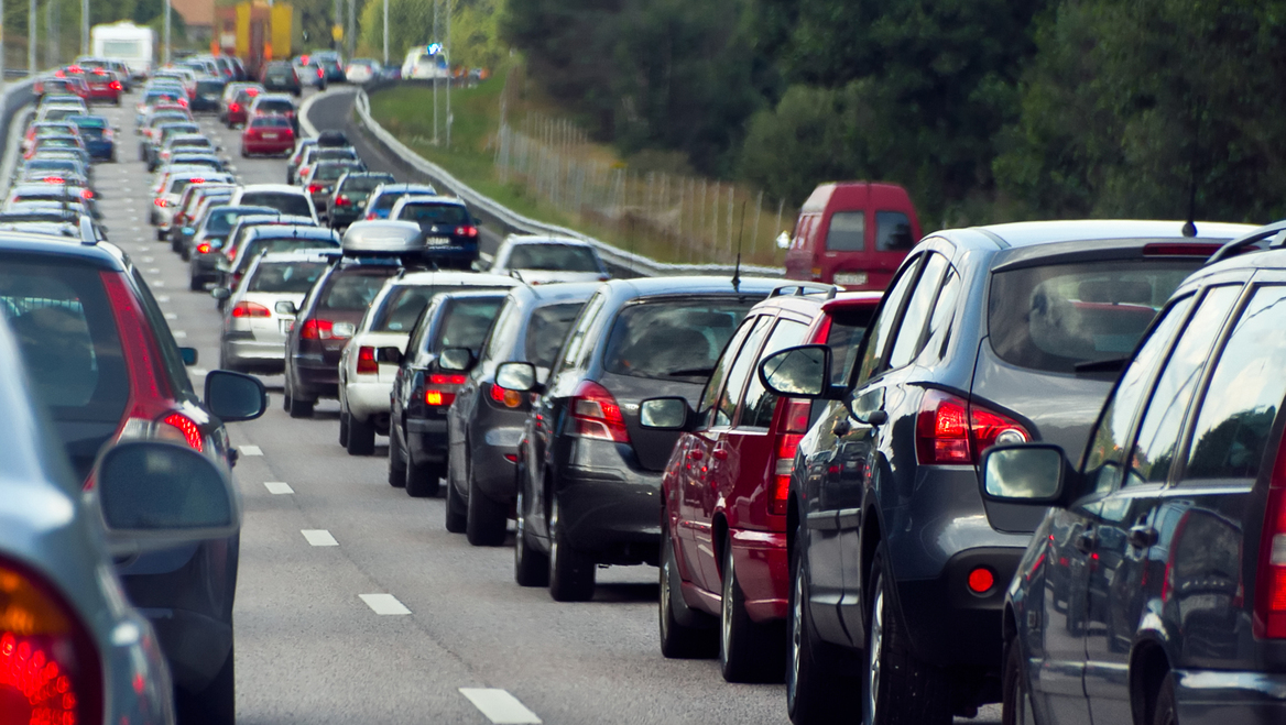 Two rows of cars are stuck at a standstill in traffic.