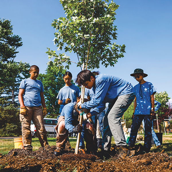 Young people from the Community Forestry Corps help plant and water trees on a school site (below) in Boulder, Colorado, in August 2025. To supply the water, Boulder planner and Senior Climate Policy Advisor Brett KenCairn (above) found an innovative temporary watering technique that relies on fire hydrants. Photos by Michael Ciaglo.