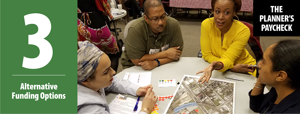 A professional woman facilitating a conversation with community members around a round table.