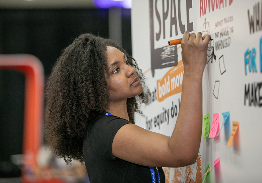 Throughout the weekend, an artist from Ink Factory translated attendees' answers on what bold moves they make for equity into several murals at the E-Space in the Hub.