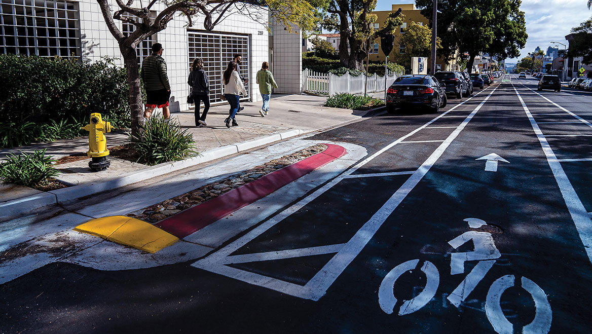 The Fourth and Fifth Avenue bike lanes are a sign of San Diego’s shift from its car-centric past to a more integrated, multimodal future. The city is also looking to maximize its parking inventory without adding substantial capital cost. Photo by Ariana Drehsler.