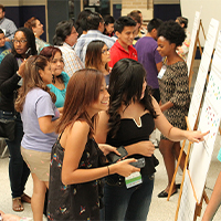 Community members review details of the new community plan at an open house. Photo courtesy of Avenue CDC and the University of Houston Community Design Resource Center.