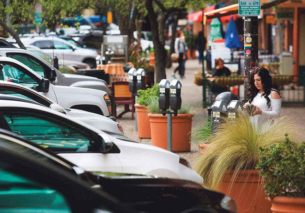 A driver pays for parking on Fourth Street in Santa Rosa, California
