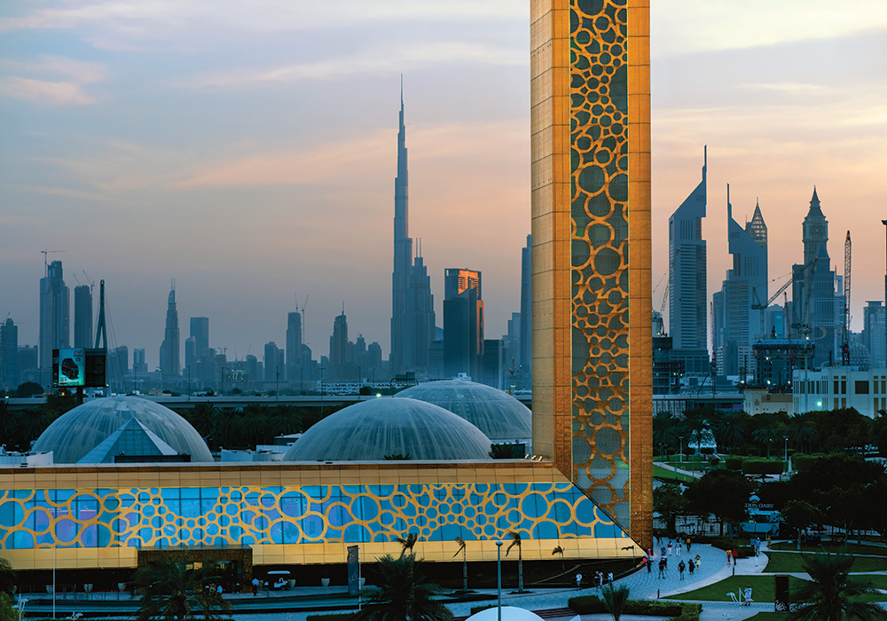 The city skyline seen through the Dubai Frame — called the biggest picture frame on the planet — in Zabeel Park. At the center is the Burj Khalifa building, the world’s tallest. Photo by pio3/Shutterstock.