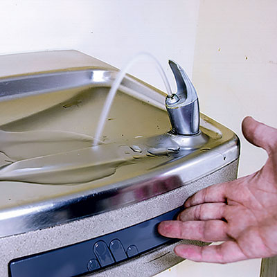 After three schools test positive for dangerous lead levels, then-Gov. Rick Snyder says the city will discontinue using Flint River water.