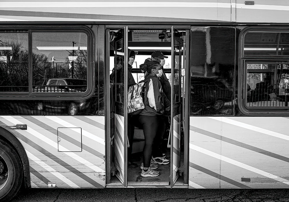 Essential workers in Detroit continue to ride city buses to their jobs despite potentially putting themselves in harm’s way. Photo by Emily Rose Bennett/The New York Times.