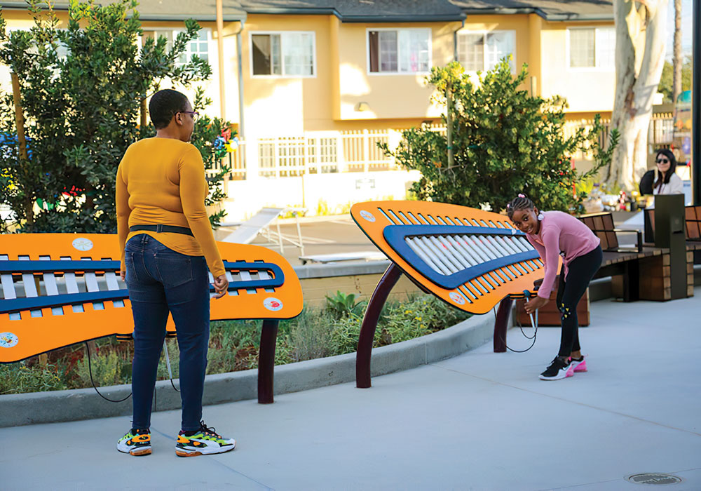 Residents try out the interactive musical play units (temporarily off-limits) at Woodcrest Play Park in Los Angeles County. Photo by Natasha Krakowiak.