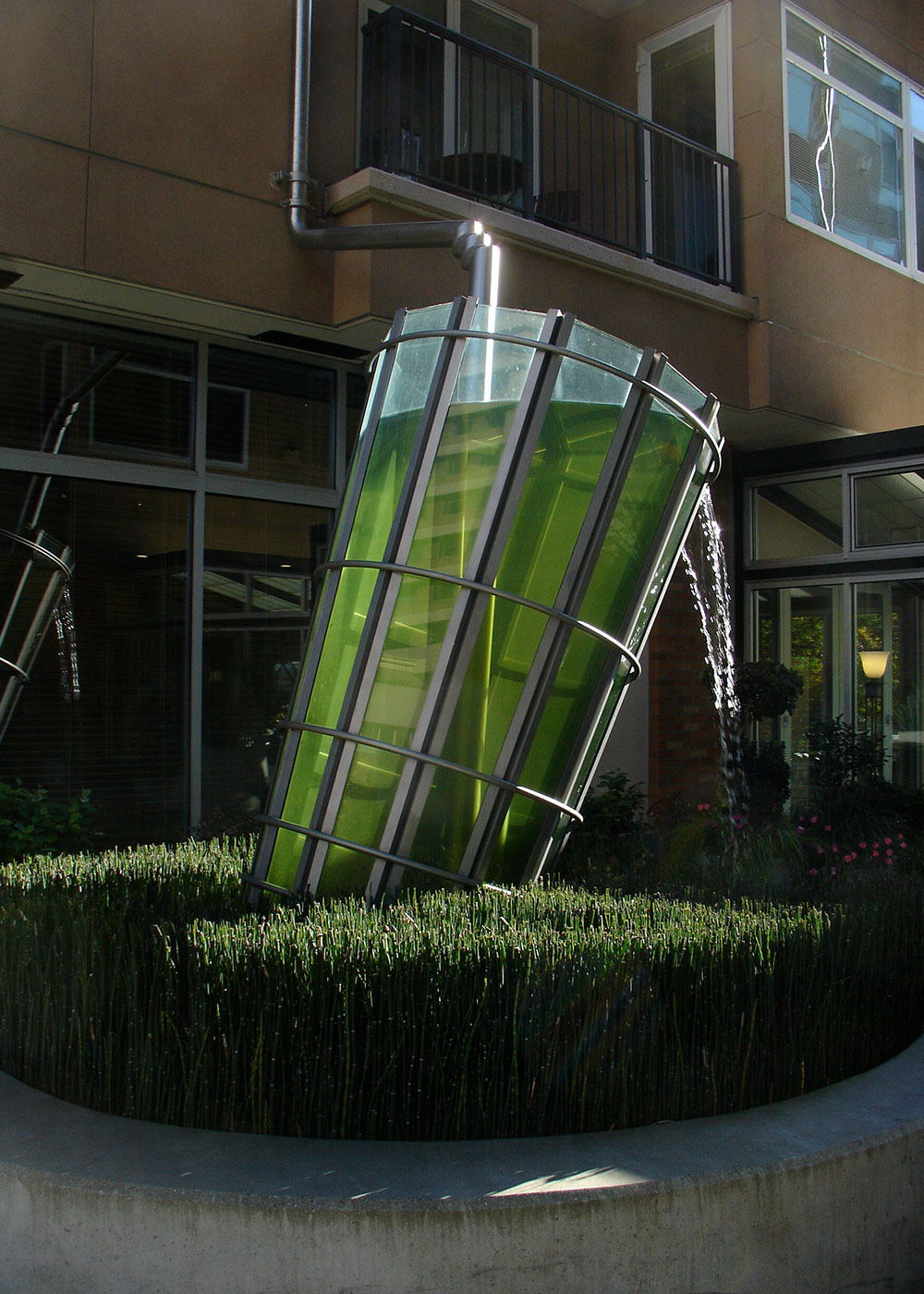 Water Table/Water Glass, a sculpture at a condominium complex in Seattle, uses its two elements to create utilitarian fountains to nurture wetlands with rainwater from the buildings’ roof. Photo courtesy Buster Simpson.