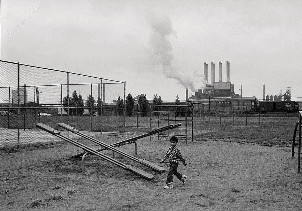 1983 photo of the Salina Elementary School playground in the shadow of the Ford Rouge Plant in Dearborn, just outside the 48217 zip code. This area is part of the cluster of industries in southwest Detroit.
