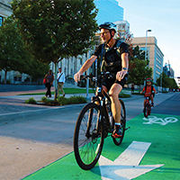 A bicyclist enjoys one of the first protected bike lanes built under the city's planokc.