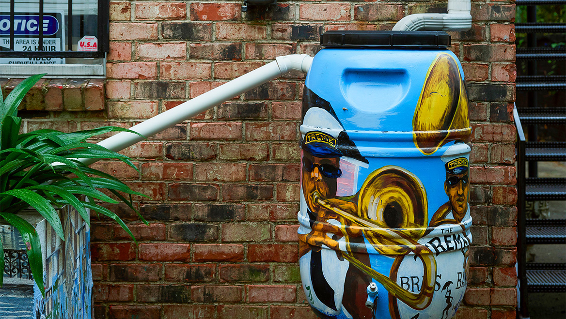 New additions outside the offices of the Greater Treme Consortium, a community group, include permeable pavers in the driveway, a bioswale, and a rain barrel. Photo by Annie Flanagan/The New York Times.