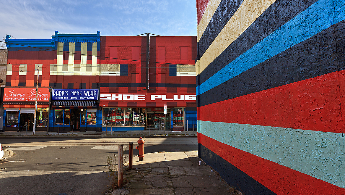 Dutch artists Jeroen Koolhaas and Dre Urhahn worked with multiple partners and agencies, including the planning department, to reenergize one of the city’s oldest commercial areas. Philly Painting by Haas&Hahn, 2500–2800 Germantown Avenue, North Philadelphia. ©2012 City of Philadelphia Mural Arts Program/Photo by Steve Weinik.