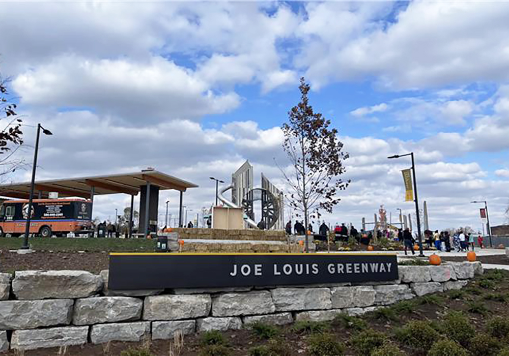 Joe Louis Greenway entrance with food trucks and fall decorations.