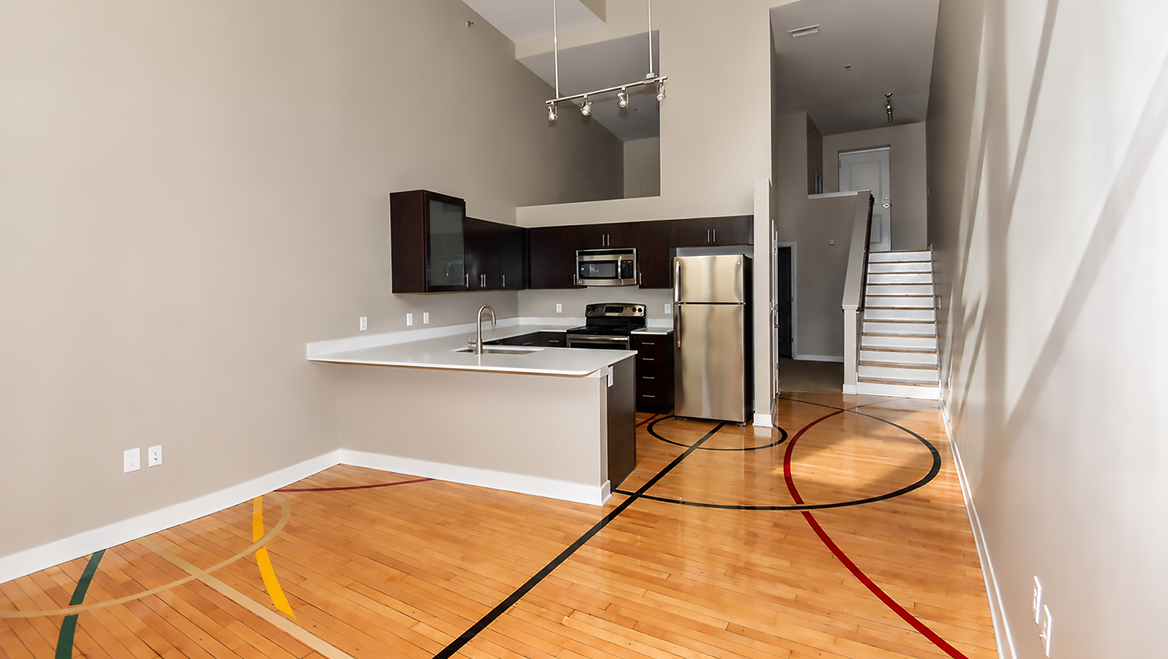 West Hill Apartments, formerly a school in Kansas City, was renovated into multifamily housing utilizing Historic Tax Credits. It even preserved elements like the old basketball court flooring in certain units. Photo courtesy of Missouri Preservation.