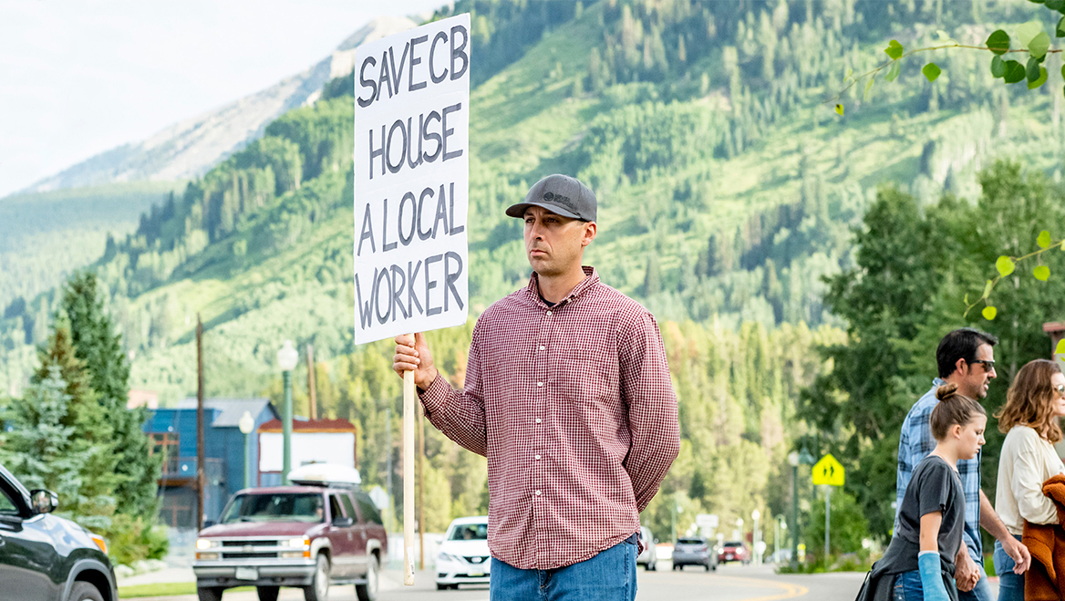 Planning October 2025 A Compass to Save the 'Last Great Ski Town' in Colorado Ben Wright, handyman and resident of Crested Butte, held a sign at a popular four-way stop for more than a month in 2021 to raise awareness about the town's housing crisis. Source: Crested Butte Community Compass, 2022.