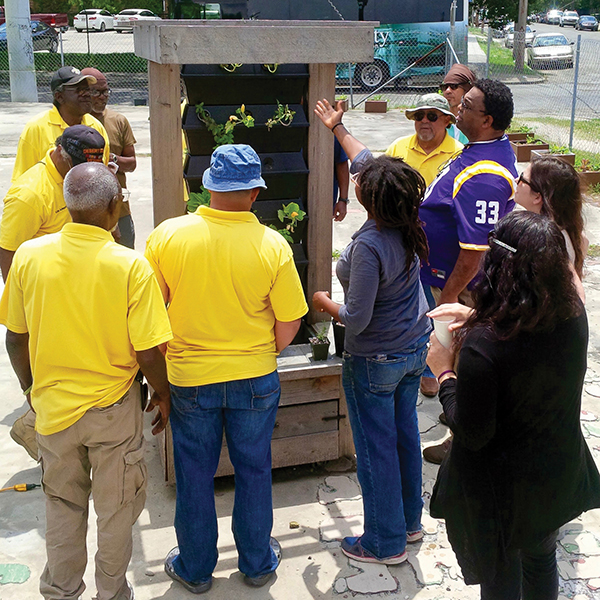 Veterans learn about vertical farming during a Recirculating Farms Growing Local NOLA class at the Carondelet Farm.