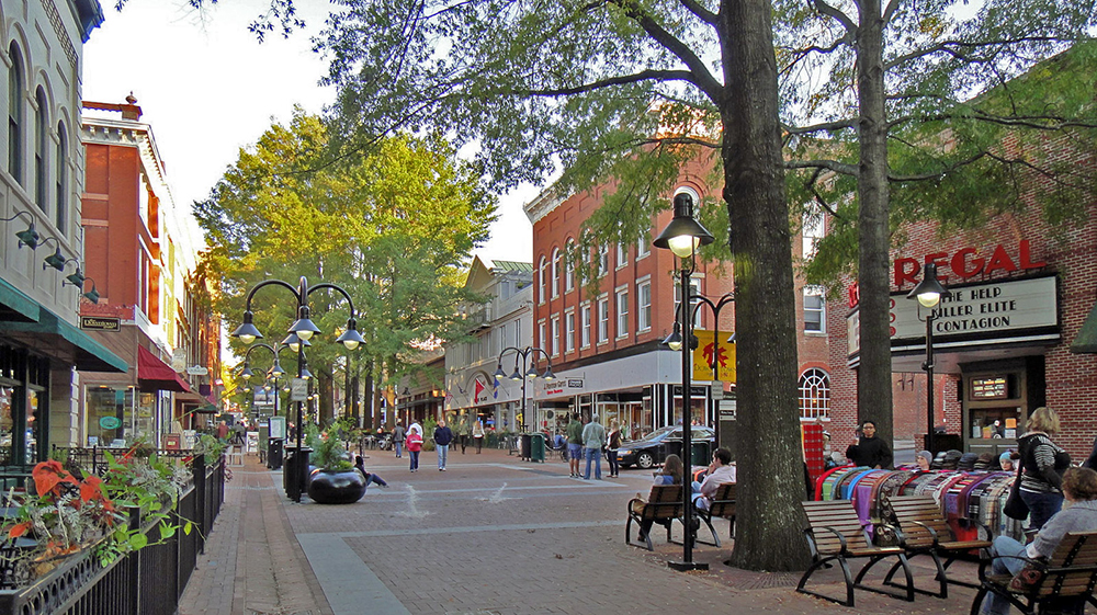 This image of Downtown Charlottesville depicts people sitting, walking, and visiting local businesses.