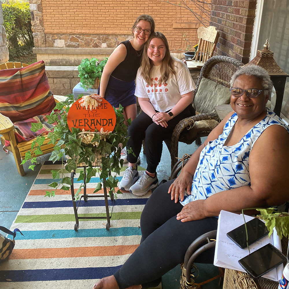Two students meet with Cultural Preservation Topic Leader, Ms. Angela Barksdale, on her veranda to discuss the cultural preservation section of the plan.