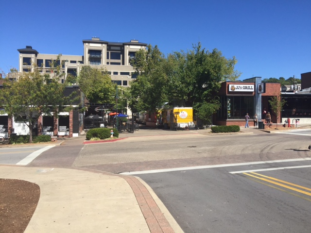 Food trucks line up in an alley alongside businesses. (Photo credit: John Gaber, AICP)