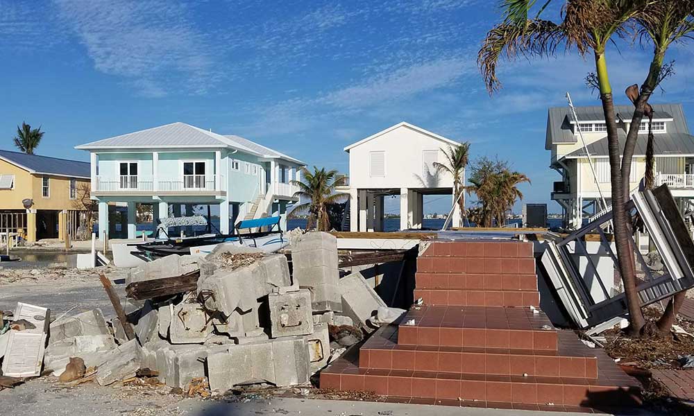 An example of wind mitigation in action in Marathon, Florida: The remnants of the home in the foreground were from an older structure, while the homes in the background were built to code. The home in the foreground was sadly unable to withstand the destruction of Hurricane Irma. Photo courtesy Julie Dennis.