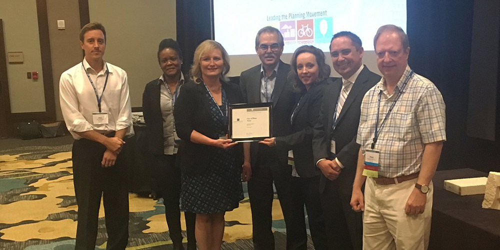 David Rouse, FAICP, presents City of Plano representatives with Silver Level