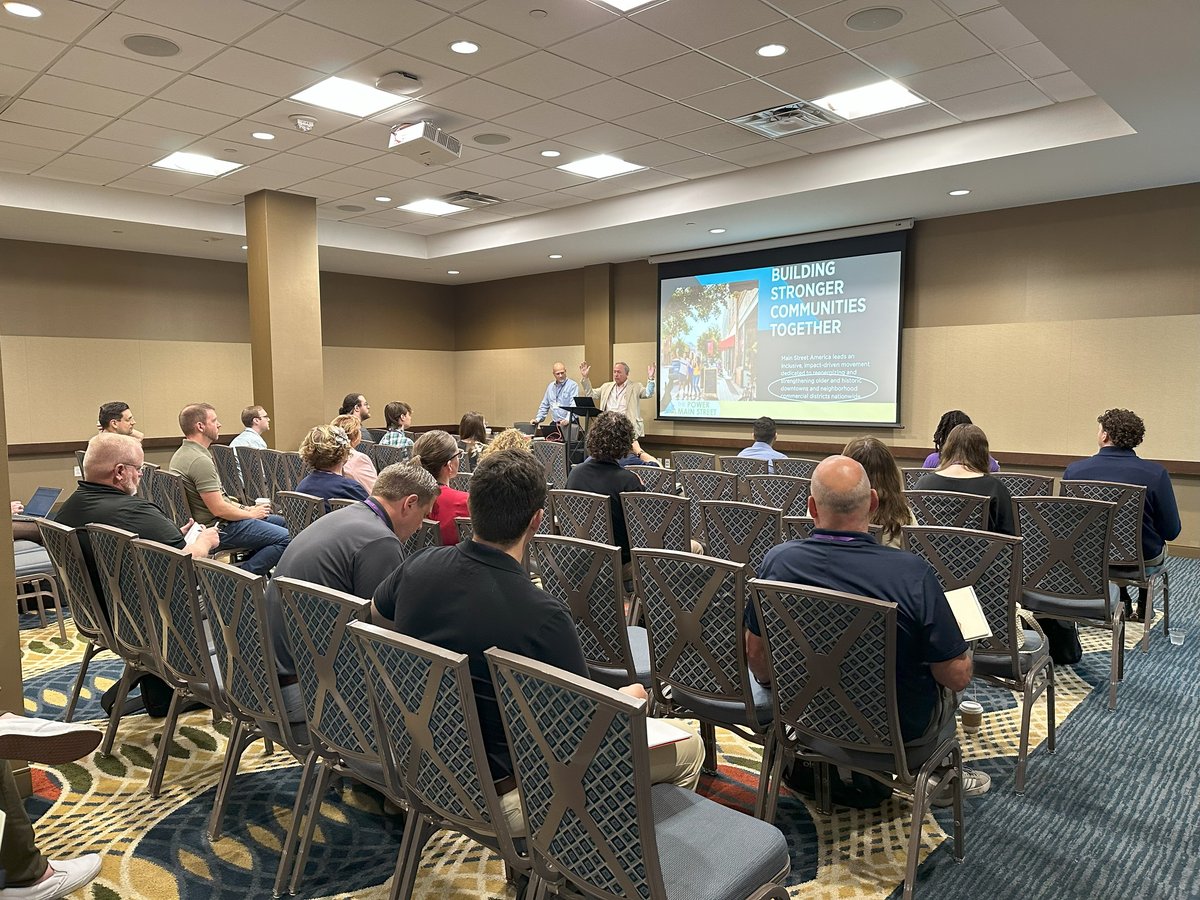 Conference attendees participating in a presentation session