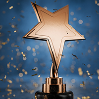 Bronze star trophy with falling confetti, symbolizing achievement.
