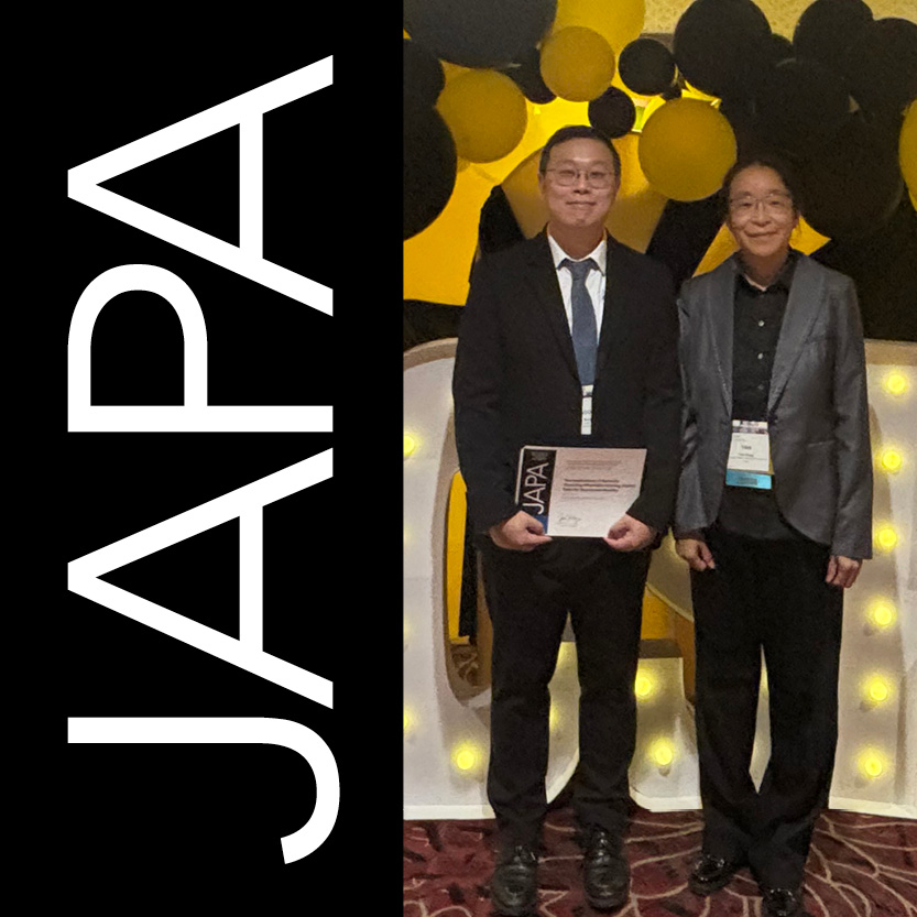 Taesoo Song and Yan Song stand by illuminated ACSP sign.
