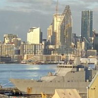 Aerial view of Auckland skyline with residential buildings and a harbor.