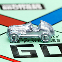 Monopoly car game piece on GO space