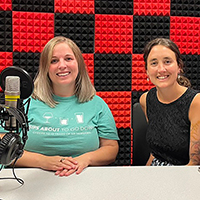 Two women podcasting.