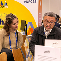 Attendees at the APA #NPC25 Career Center, reviewing materials and discussing opportunities.