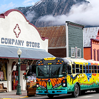 Colorful bus parked in front of historic The Company Store.