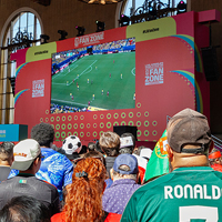 Fans watch a soccer match on a large screen at the Los Angeles Fan Zone.