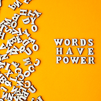 A bunch of wooden letters on a yellow background