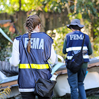 Workers for FEMA surveying a home following a natural disaster