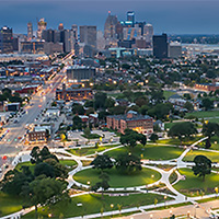 Aerial view of Detroit's downtown at dusk, with Roosevelt Park in the foreground.