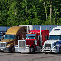 semi trucks parked in a line