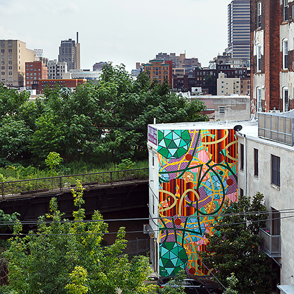 Injecting color into a post-industrial neighborhood, this work was created in partnership with Mural Arts teaching artists and high school students. Untitled, by Charles Burwell, 1016 Hamilton Street. ©2017 City of Philadelphia Mural Arts Program.