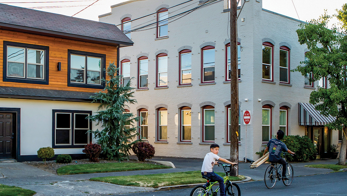 An older apartment next to a recently constructed multi-unit building on Birch Street.