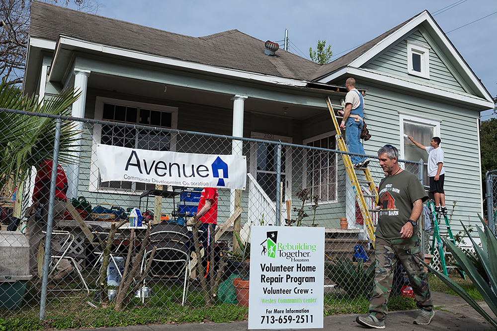 As part of the Rebuilding Together initiative, volunteer crew members work together to renovate a home