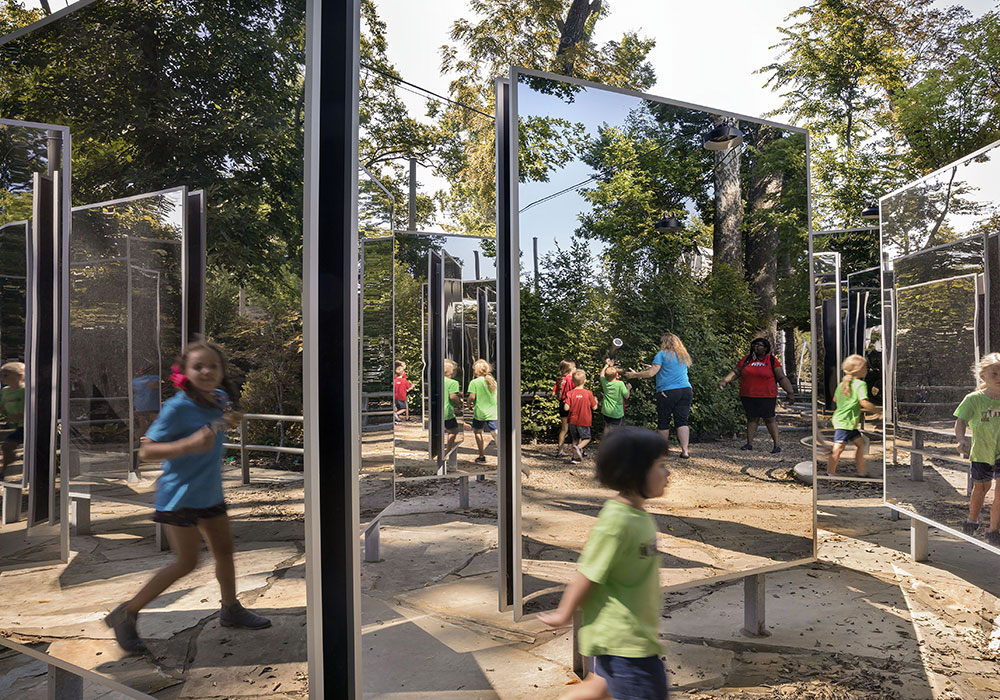 Children playing in a mirrored play area. Photo courtesy A Gathering Place for Tulsa.