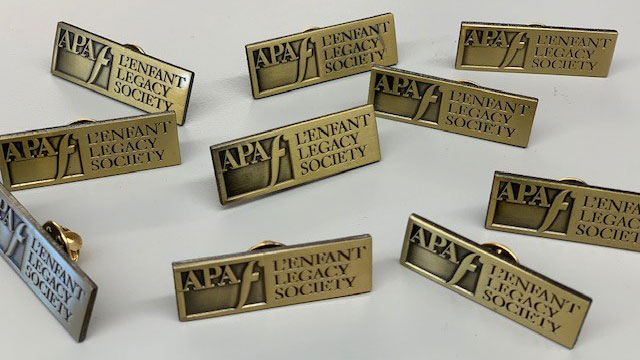 This image features the enamel pin presented to donors of the L'Enfant Legacy Society