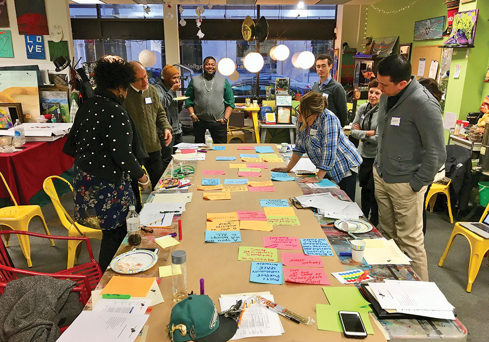 The author (second from left) at a strategy session with a group of community advisors. Photo by Laura Masulis.