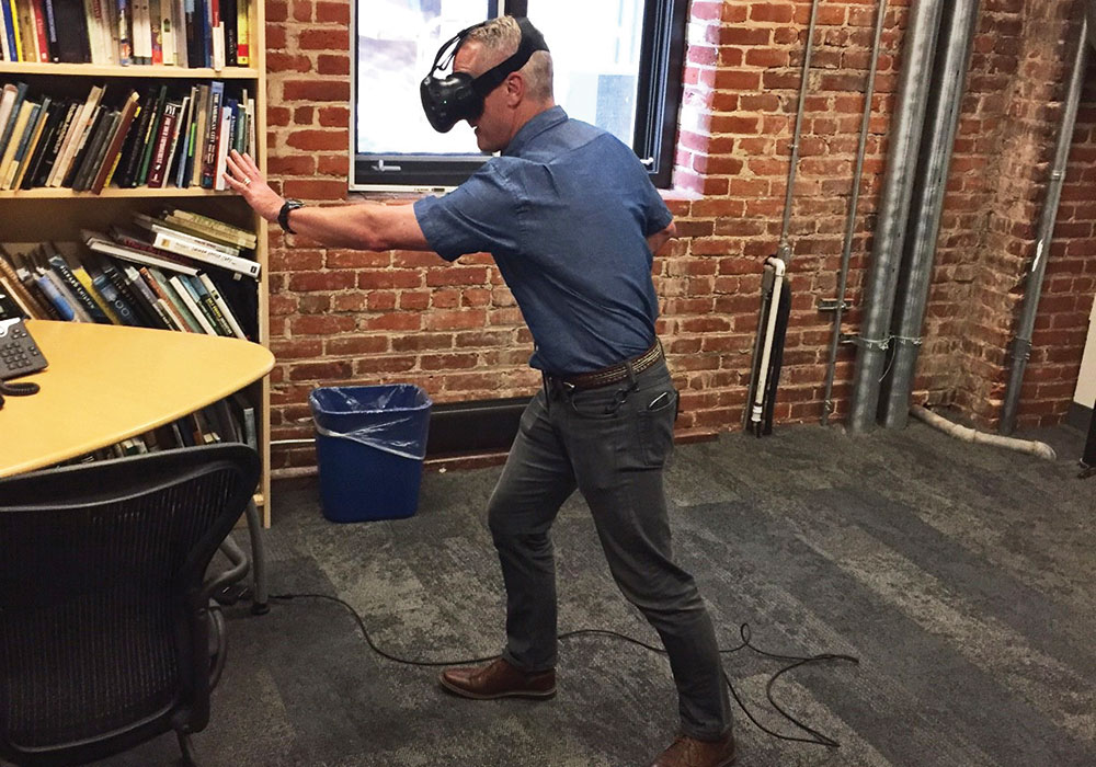 A VR user takes his turn exploring the concept for Broadway Viaduct Park in Denver — moving through the space, navigating the design, and mimicking the path transit users and pedestrians would use. Photo courtesy Design Workshop, Inc.