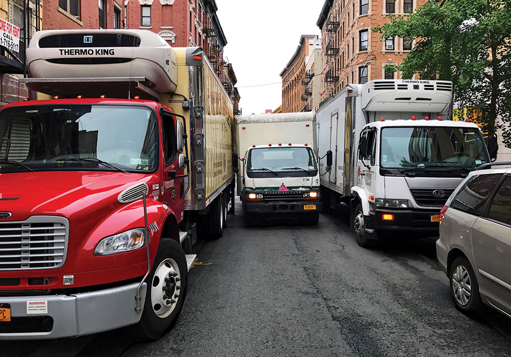 This tight squeeze on a New York City street is a not-so-rare sight thanks to our ever-increasing demand for deliveries around the clock. Photo by Tom Visée.