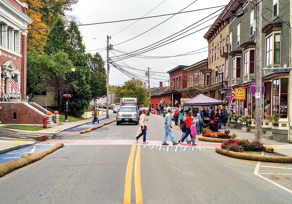 Residents in Bethel, Vermont, teamed up with AARP Livable Communities and Team Better Block to test bulb-outs, crosswalks, a mobility lane, and a parklet. The experiment led to permanent street changes and the revitalization of several downtown buildings. Photo courtesy Team Better Block.